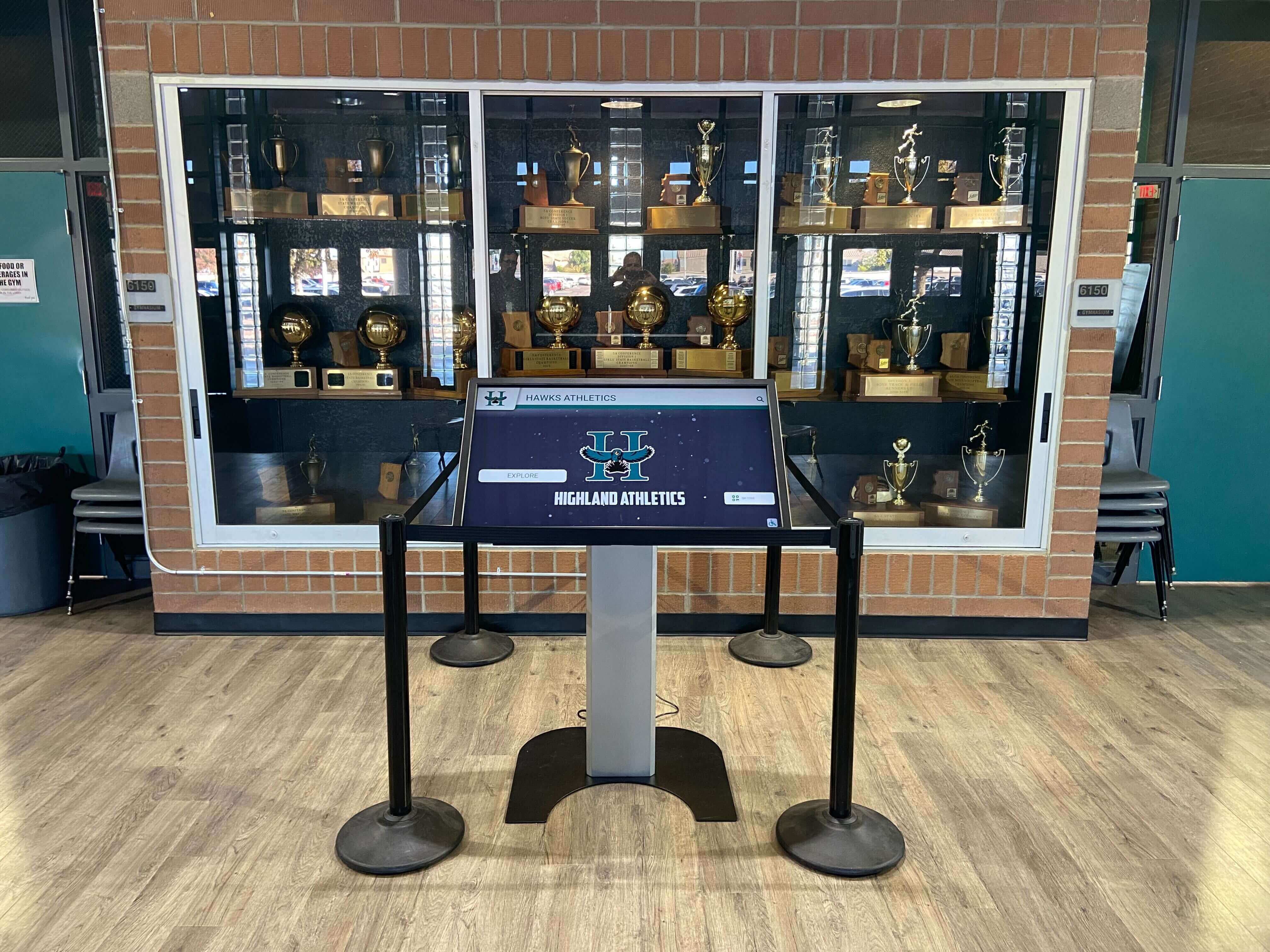 Modern athletic recognition display in school trophy case Athletic recognition display