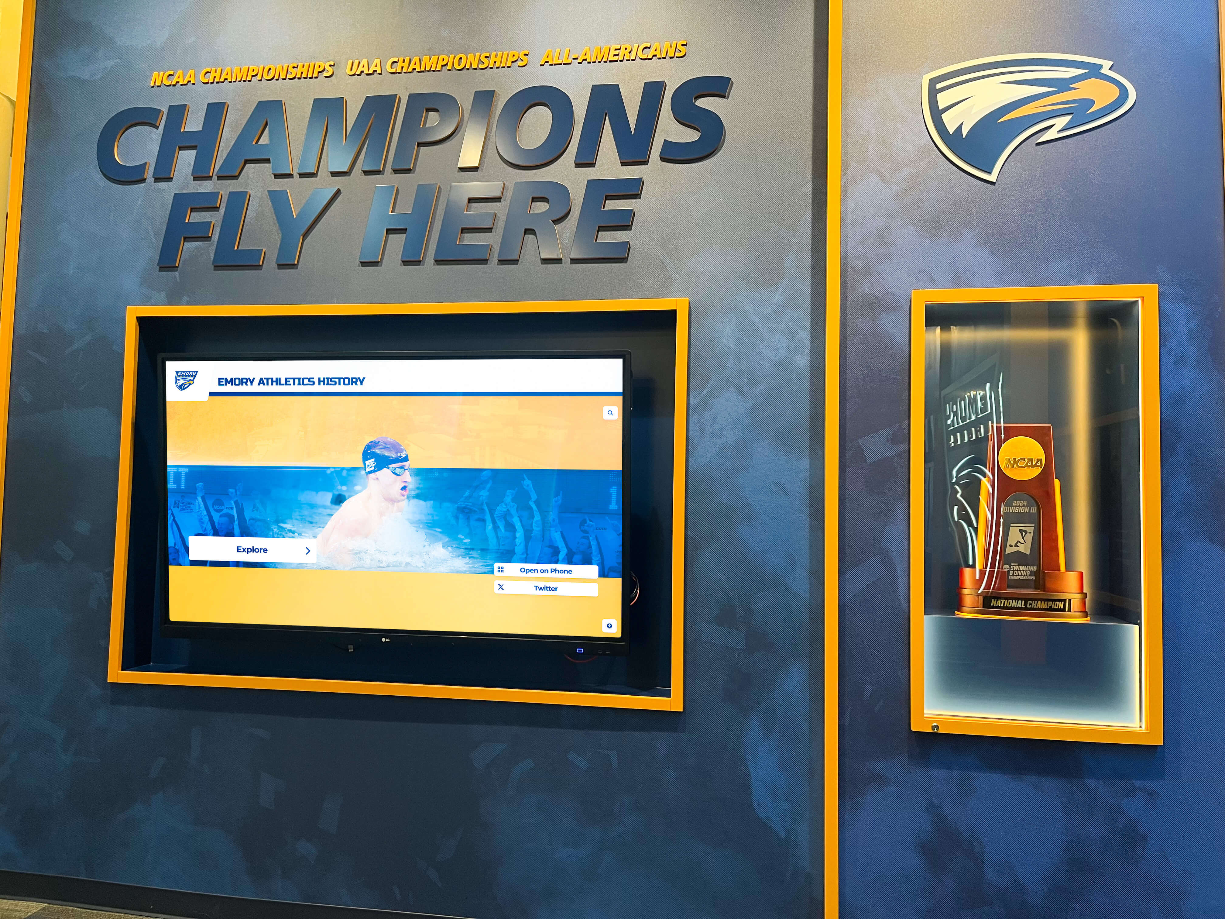 University athletics champions wall celebrating team achievements Championship recognition wall
